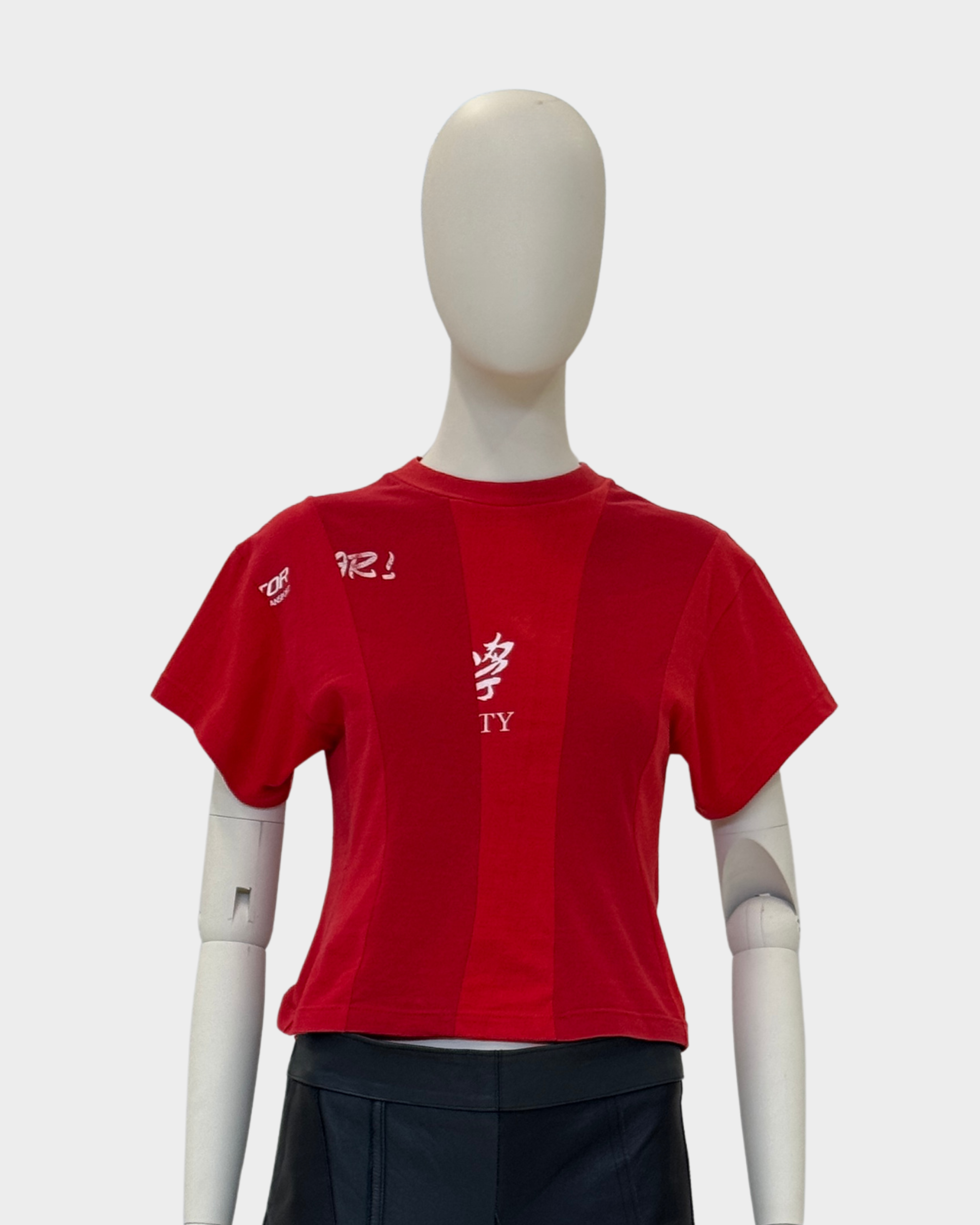 Red t-shirt with white text on a mannequin against a gray background