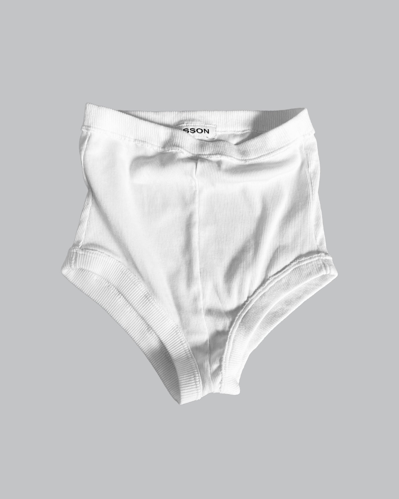 A pair of white ribbed mini shorts for women, displayed against a plain background.